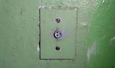Close-up of old elevator button. Ancient soviet button on concrete wall with Foto stock