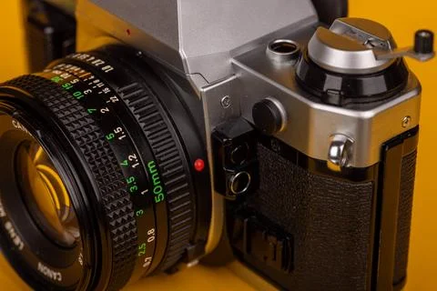Close-up of an old-fashioned camera with a focus on the lens, set against a.. Stock Photos