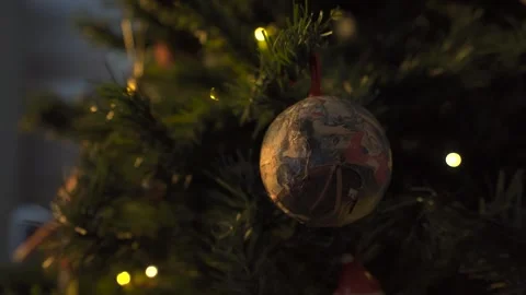 Close up on old fashioned decorative ball on Christmas tree with blinking lights Stock Footage 257655948