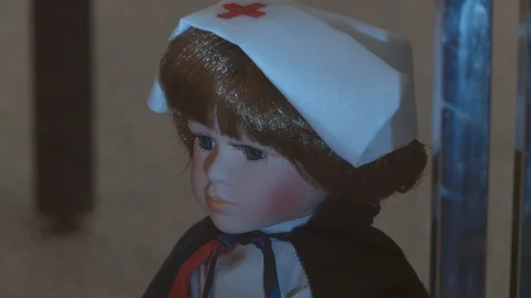 Close up of old-fashioned doll wearing nurse's uniform. Vídeo Stock 111343747