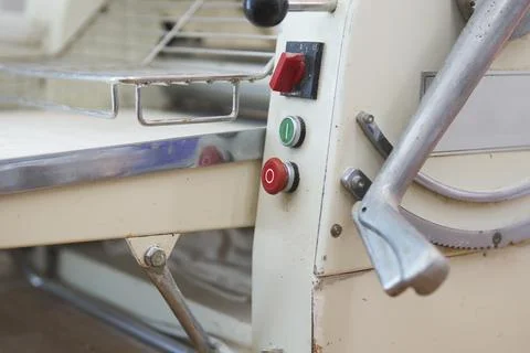 Close up of old fashioned machine for rolling out pastry in bakery Stock Photos