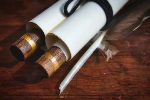 Close-up of old-fashioned paper scroll with a feather quill pen Stock Photos