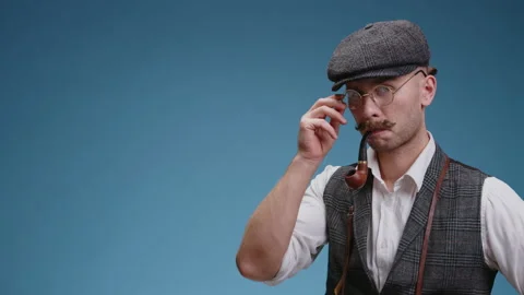 Close up of old fashioned reporter dressed in retro suit and a vest with a cap Stock Footage 167978070