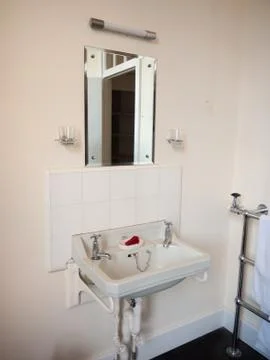 Close up of old fashioned retro styled bathroom sink and mirror Stock Photos