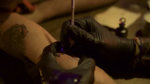 Close up of old fashioned tattooing method Stock Footage 84900794