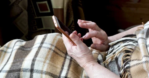 Close-up of an old female hands with a mobile phone Stock Footage 128657373