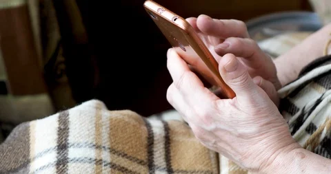 Close-up of an old female hands with a mobile phone Stock Footage 128657392