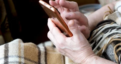 Close-up of an old female hands with a mobile phone Stock Footage 128657425