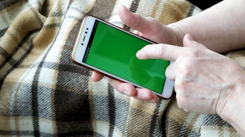 Close-up of an old female hands with a mobile phone Stock Footage 128657446