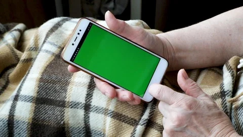 Close-up of an old female hands with a mobile phone Stock Footage 128657482