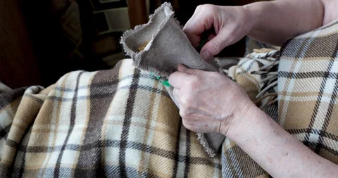 Close-up of an old female hands packing a small present Stock Footage 128657691