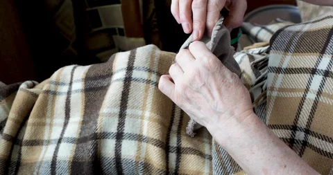 Close-up of an old female hands packing a small present Stock Footage 128657757