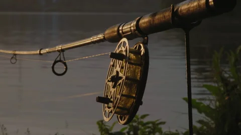 Close-up, Old Fishing Rod in the Rays of the Setting Sun Stands on a Stand on Stock Footage 157054280