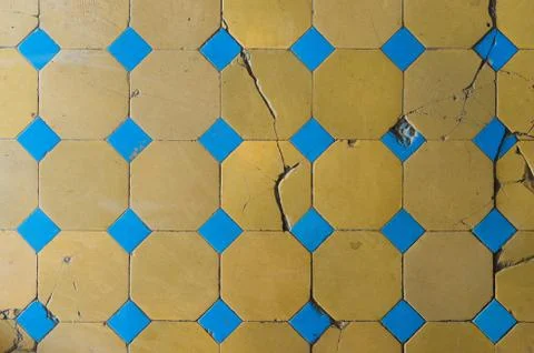 Close-up of an old floor tile with a two-tone pattern. Chapped floor tiles Stock Photos