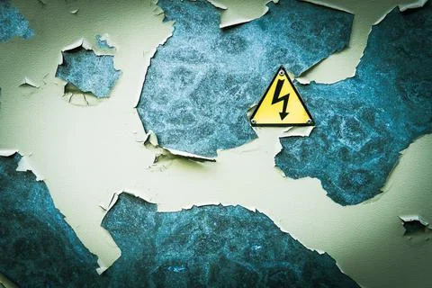 Close up of old Grey Hinged Power Supply Box with yellow danger warning sign. Stock Photos