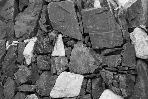 Close-up of old gritty stone structure in greyscale Stock Photos