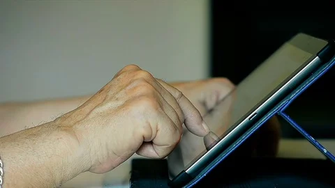 Close-Up Old Hands of the Elderly Person Using Tablet IPad at Home Stock Footage 78099579