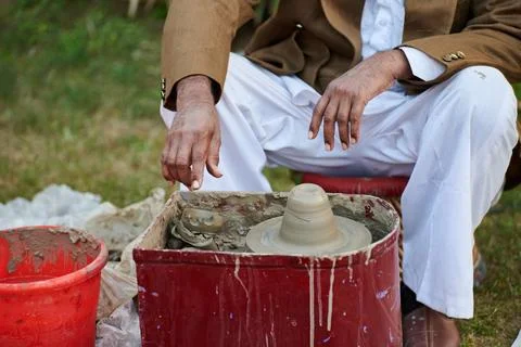 Close up old indian man hand makes pottery items from clay, old potter crea.. Stock Photos