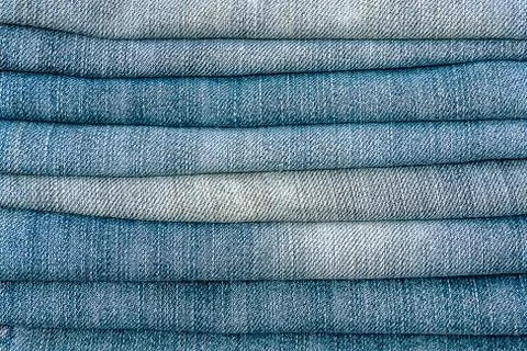 Close-up old Jeans trousers stack background texture. Stock Photos