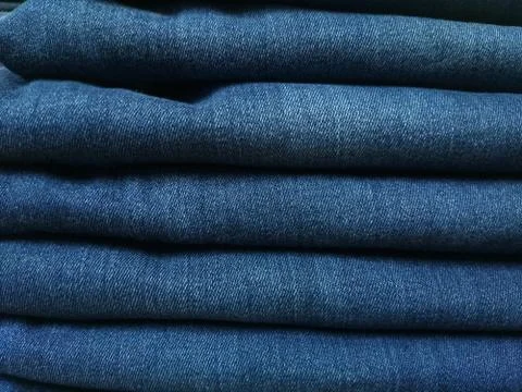 Close-up old Jeans trousers stack background texture. Stock-Fotos