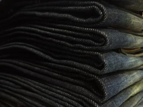 Close-up old Jeans trousers stack background texture. Stock Photos