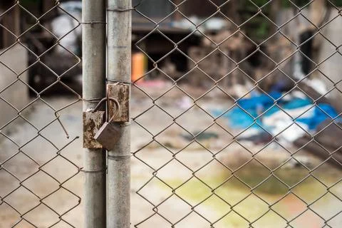 Close up of an old lock and a rusty chain on an iron gate Stock Photos