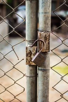 Close up of an old lock and a rusty chain on an iron gate Stock Photos