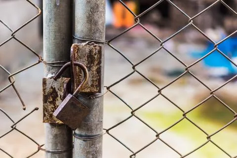 Close up of an old lock and a rusty chain on an iron gate Stock Photos