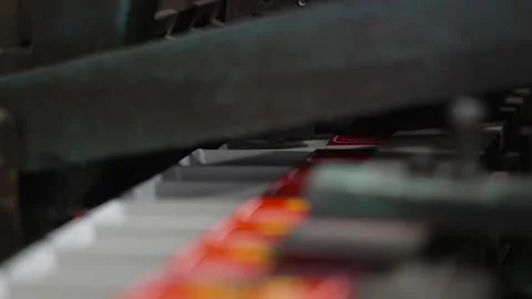 Close up of old machine mechanism moving matchboxes along production line in Stock Footage 348984092