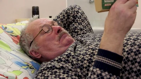 Close-up old man read the book in hosp Stock Footage 81836495