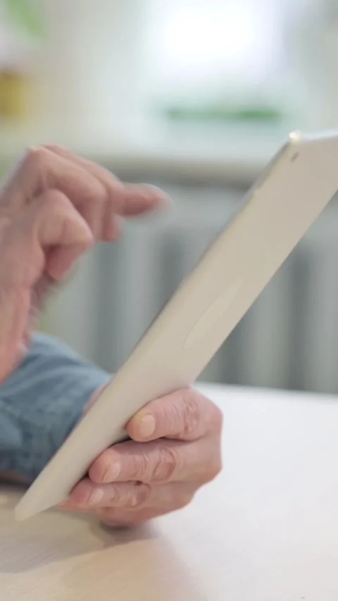 Close up of Old Man Using Digital Tablet, vertical video Video stock 329107185