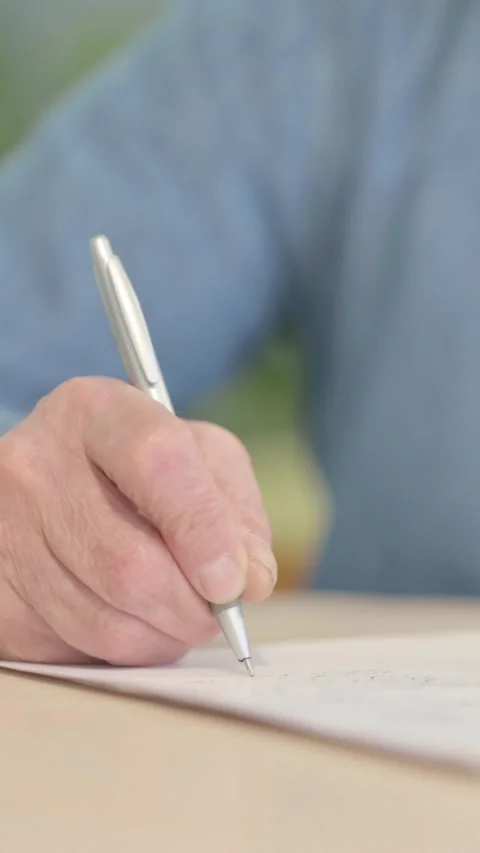 Close up of Old Man Writing in Office, vertical video Video stock 329107112
