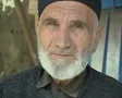 Close up of old man's face while sharpening knife SD Footage
