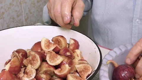 Close-up of an old man's hand cut fruit. Hand holds fig fruit. Stock Footage 137787188