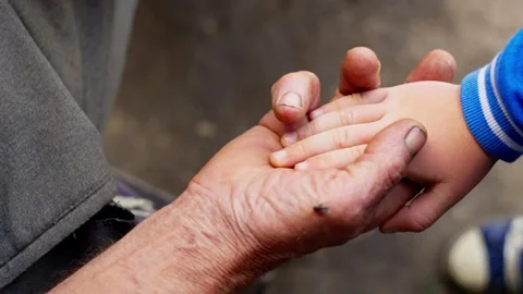 Close-up of an old man's hand holding a child's hand. Stock Footage 248641671