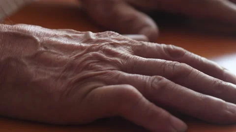 Close-up of an old man's hand on the table. selective focus. the process of.. Stock Footage 238716585