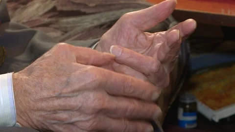 Close-up of the old man's hands with the wrinkled skin shaking . Stock Footage 126604613