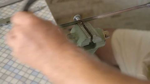 Close-up, Old Men Saws Saw for Metal Clamped in Vise Bolt Stock Footage 92307794