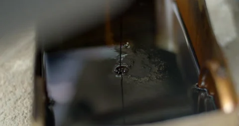 Close up old oil drained from the engine.Old oil is black and very viscous. Stock Footage 289855169