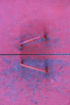 Close up old pink metal door with handles Stock Photos