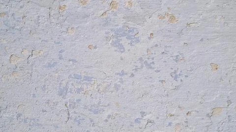 Close-up of old plaster wall with peeling paint and cracks. Stock Photos