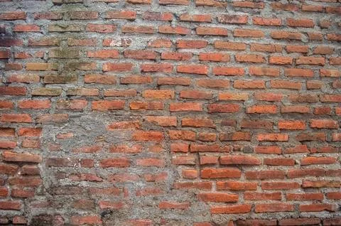 Close up of an old red brick wall, revealing weathered texture, damaged mor.. Stock Photos