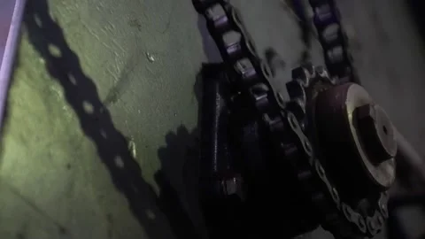 Close-up of an old rotating roller chain and drive star Stock Footage 172452455
