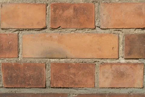 Close-up of old rustic brick wall with weathered textures Foto stock