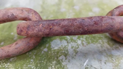 Close-up of an Old Rusty Chain on a Green Background Stock Footage 333642308