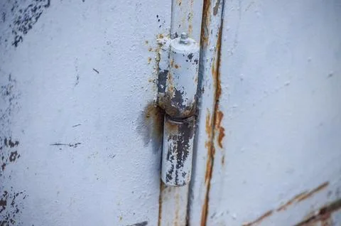Close-up of an old rusty garage hinge. Stock Photos