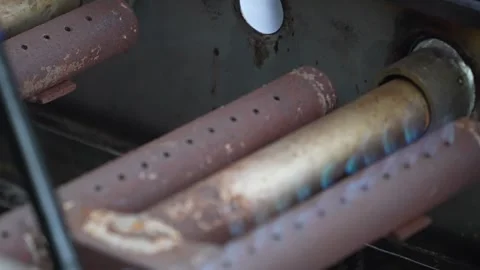 Close-up of old rusty gas burner igniting with blue flames Stock Footage 346503269