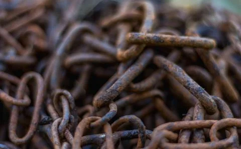 Close-up of old rusty iron chains, highlighting weathered metal texture, corr Stock Photos