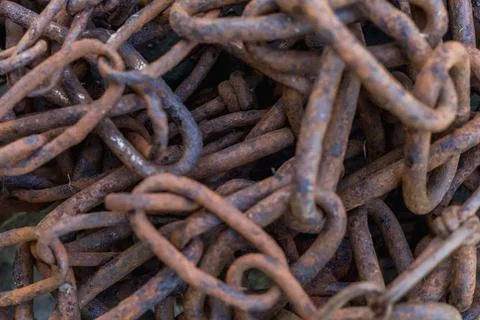 Close-up of old rusty iron chains, highlighting weathered metal texture, corr Fotos Stock