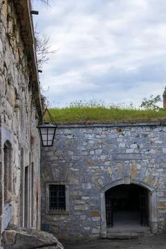 Close up of an old rusty iron ring mounted on a stone wall, historic detail.. Stock Photos